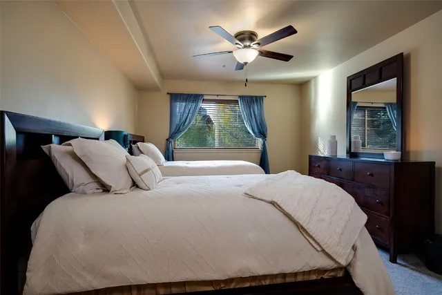 a bedroom with a large bed and a large window