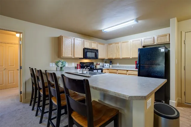 a kitchen with a table and chairs