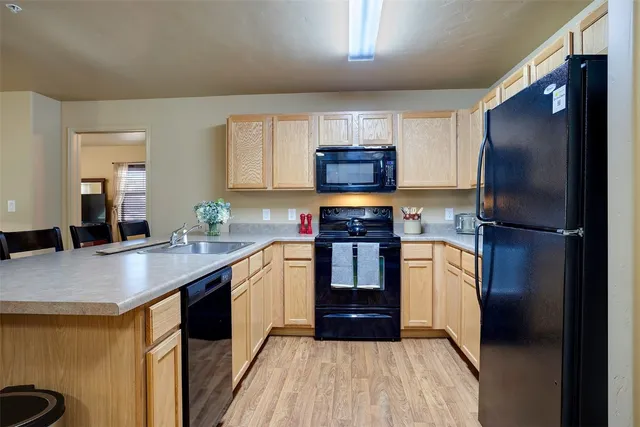 a kitchen with stainless steel appliances a refrigerator sink and microwave