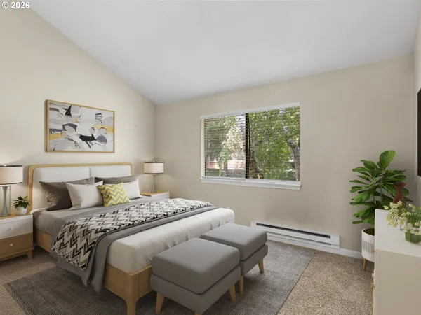 a bedroom with a bed and a painting on the wall