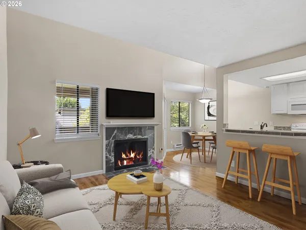 a living room with furniture a flat screen tv and a fireplace