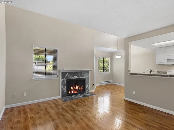 a view of an empty room with a fireplace and a window