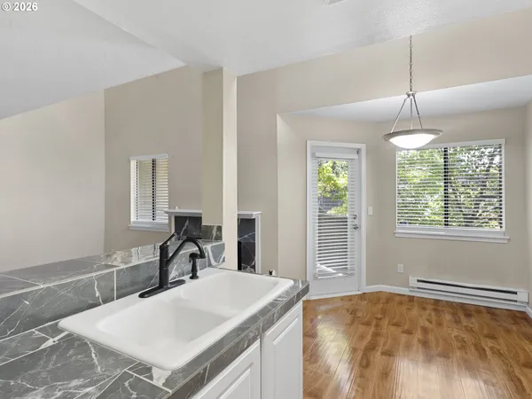 a kitchen with a stove a sink and a refrigerator