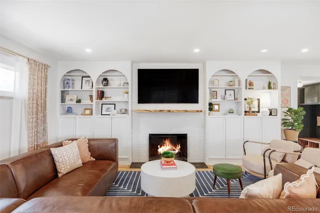 a living room with furniture fireplace and a flat screen tv