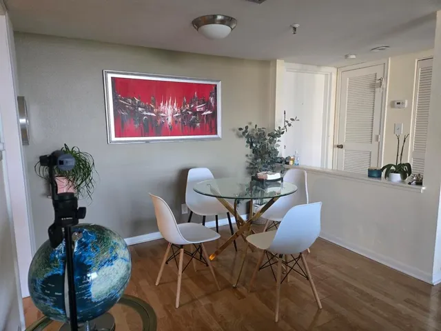a view of a dining room with furniture wooden floor and a chandelier
