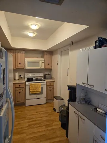 a kitchen with a sink stove and refrigerator