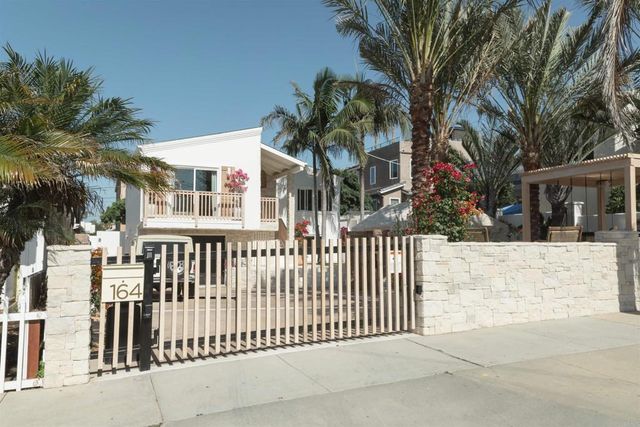 a view of a house with a small yard and plants