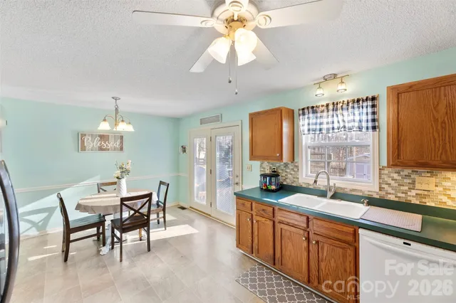 a bathroom with a sink a toilet a mirror and shower curtain
