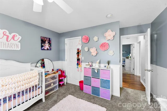 a bedroom with a large bed and a chandelier