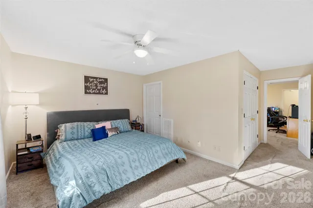 a backyard of a house with wooden chairs and a barbeque