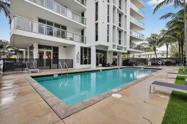 a view of a swimming pool with a lounge chairs