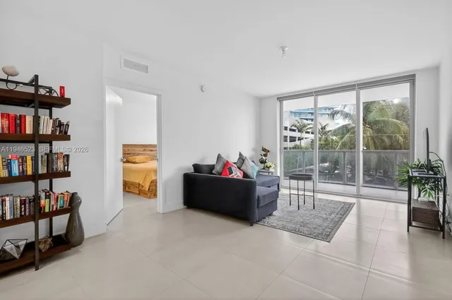 a living room with furniture and a book shelf