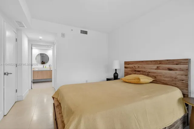 a bedroom with a bed and walk in closet