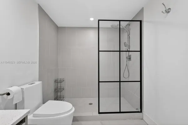 a bathroom with a shower toilet and sink