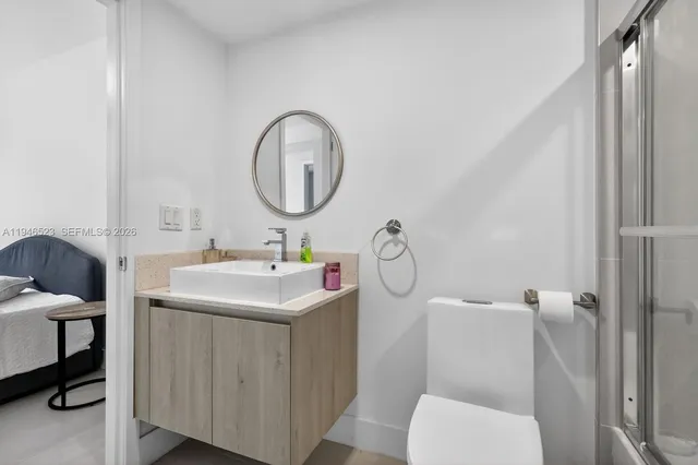 a bathroom with a toilet sink and mirror
