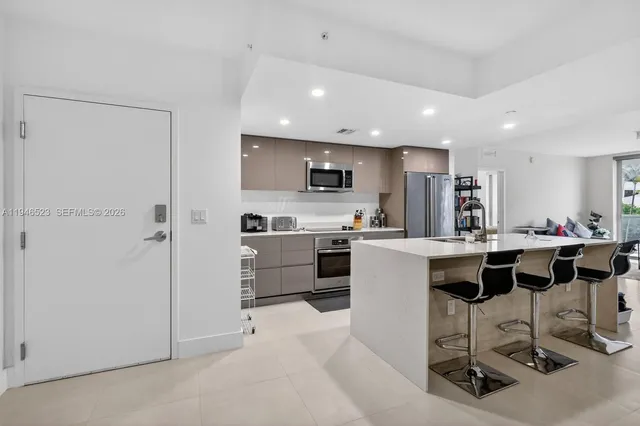 a kitchen with cabinets and chairs