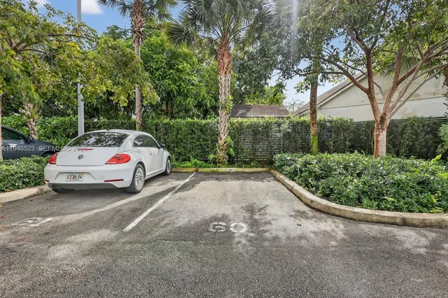 a white house covered with tall trees