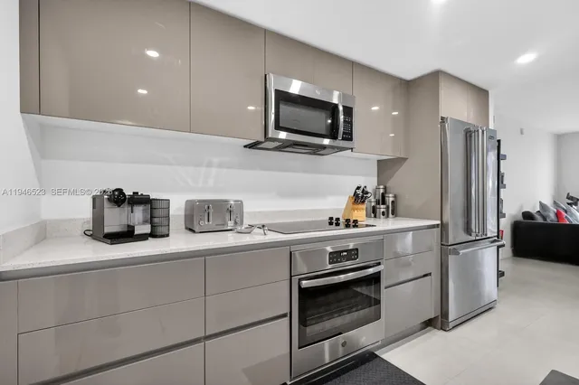 a kitchen with kitchen island granite countertop stainless steel appliances and sink