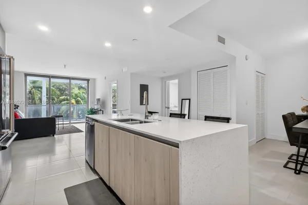 a large white kitchen with a large window