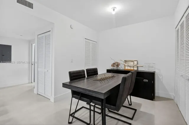 a view of a workspace with furniture and wooden floor