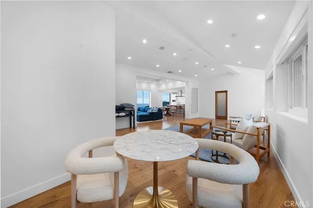 a large white kitchen with cabinets a sink and a stove