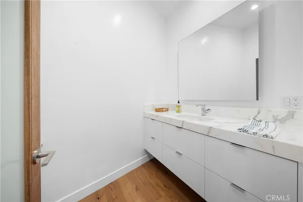 a large bathroom with a double vanity sink mirror and bathtub