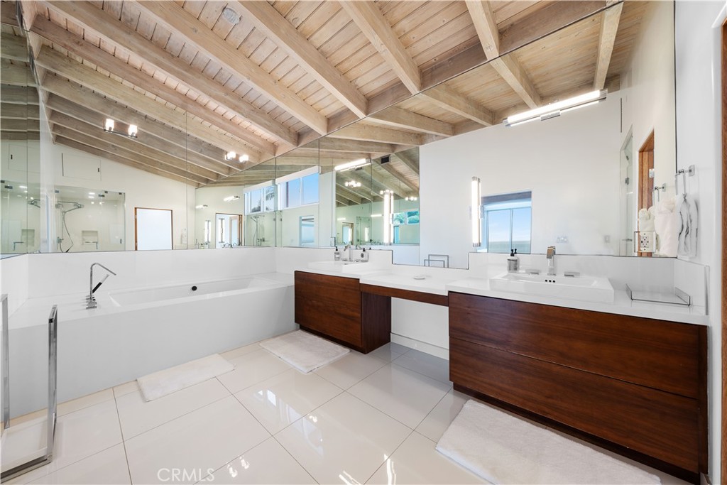 31654 Broad Beach Road Malibu, CA 90265 - Photo 29 of 75 a large bathroom with a large tub sink vanity and mirror