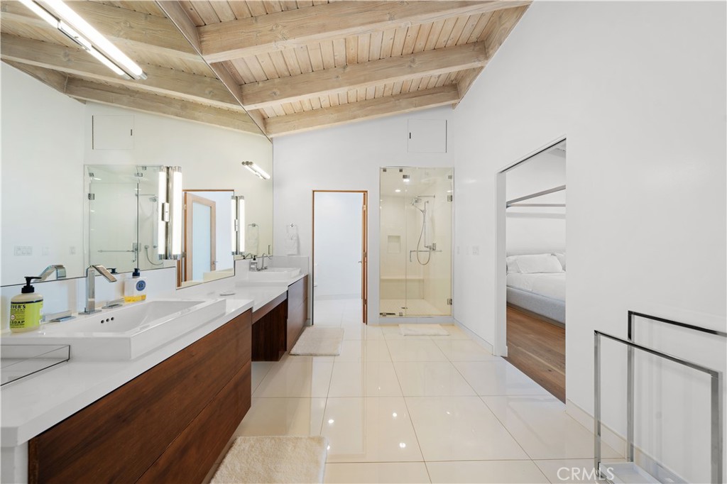 31654 Broad Beach Road Malibu, CA 90265 - Photo 30 of 75 a large bathroom with a granite countertop double vanity sink a mirror and a shower