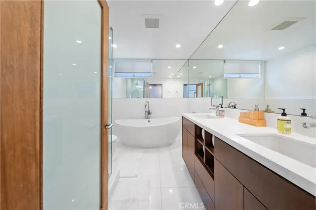 a bedroom with a bed and a flat tv screen on the dresser