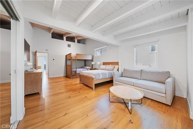 a view of a roof deck with couches under an umbrella