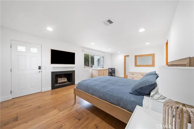a view of a balcony with chairs and wooden floor