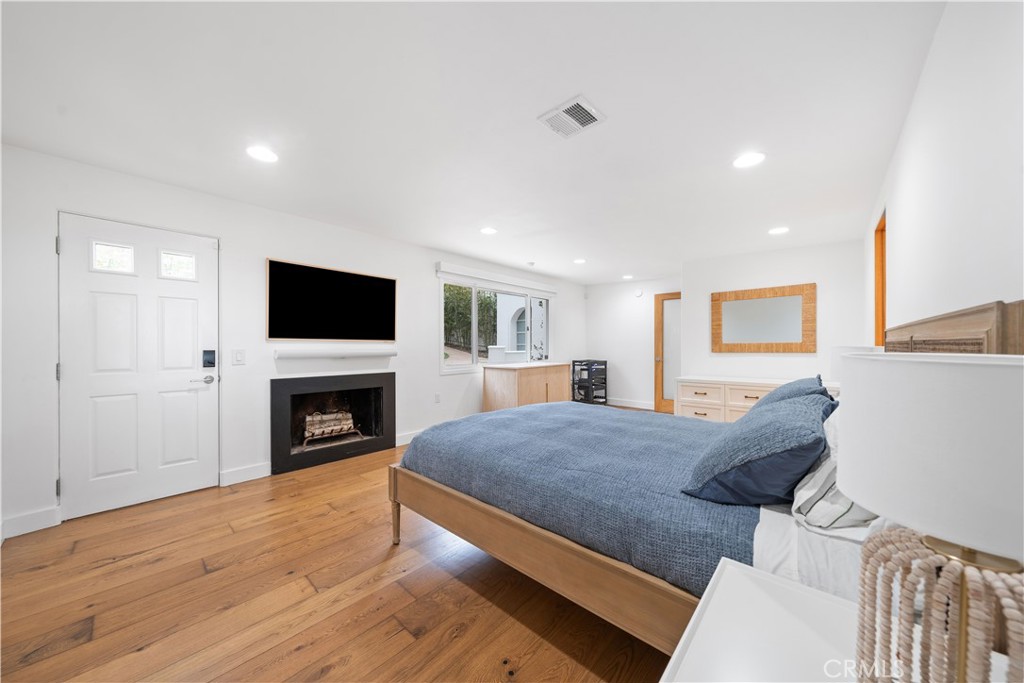 31654 Broad Beach Road Malibu, CA 90265 - Photo 40 of 75 a living room with furniture a fireplace and a flat screen tv