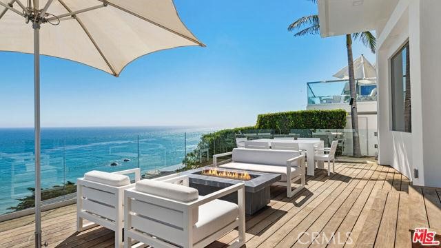 31654 Broad Beach Road Malibu, CA 90265 - Photo 43 of 75 a view of a roof deck with couches under an umbrella