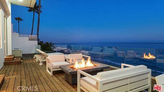 31654 Broad Beach Road Malibu, CA 90265 - Photo 52 of 75 a view of a balcony with chairs and wooden floor