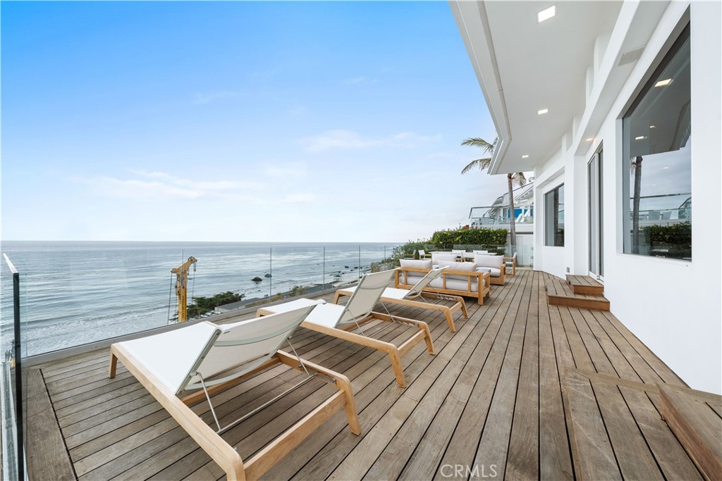 31654 Broad Beach Road Malibu, CA 90265 - Photo 62 of 75 a view of a balcony with wooden floor and outdoor seating