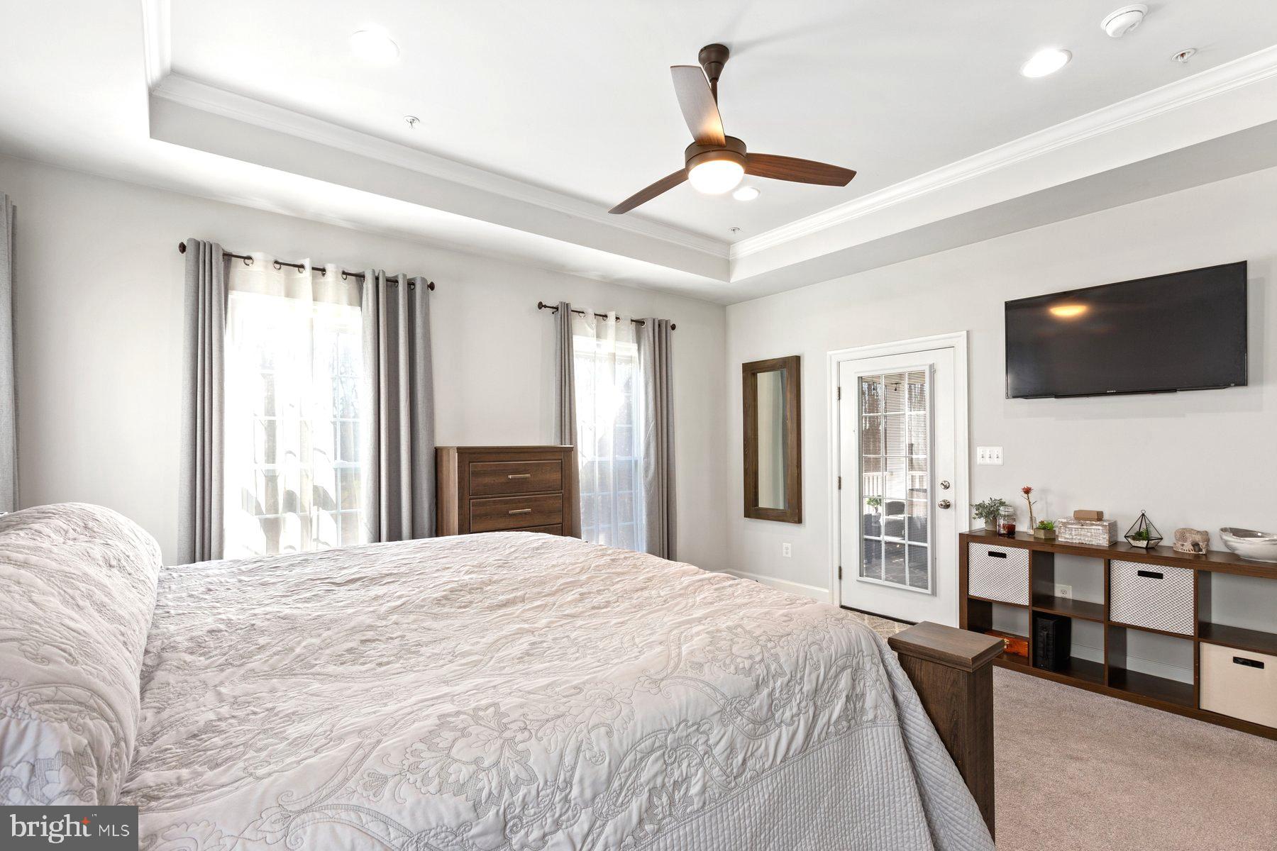 12508 Barnard Court Brandywine, MD 20613 - Photo 15 of 35 a bedroom with a bed a flat screen tv and couches