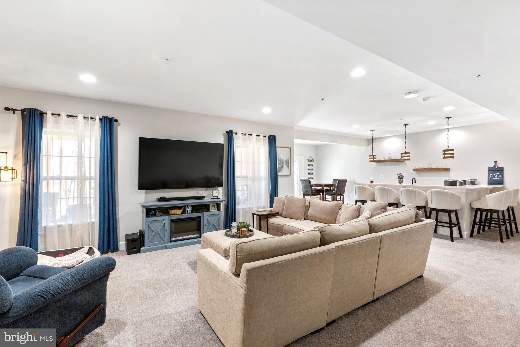 12508 Barnard Court Brandywine, MD 20613 - Photo 27 of 35 a living room with furniture and a flat screen tv