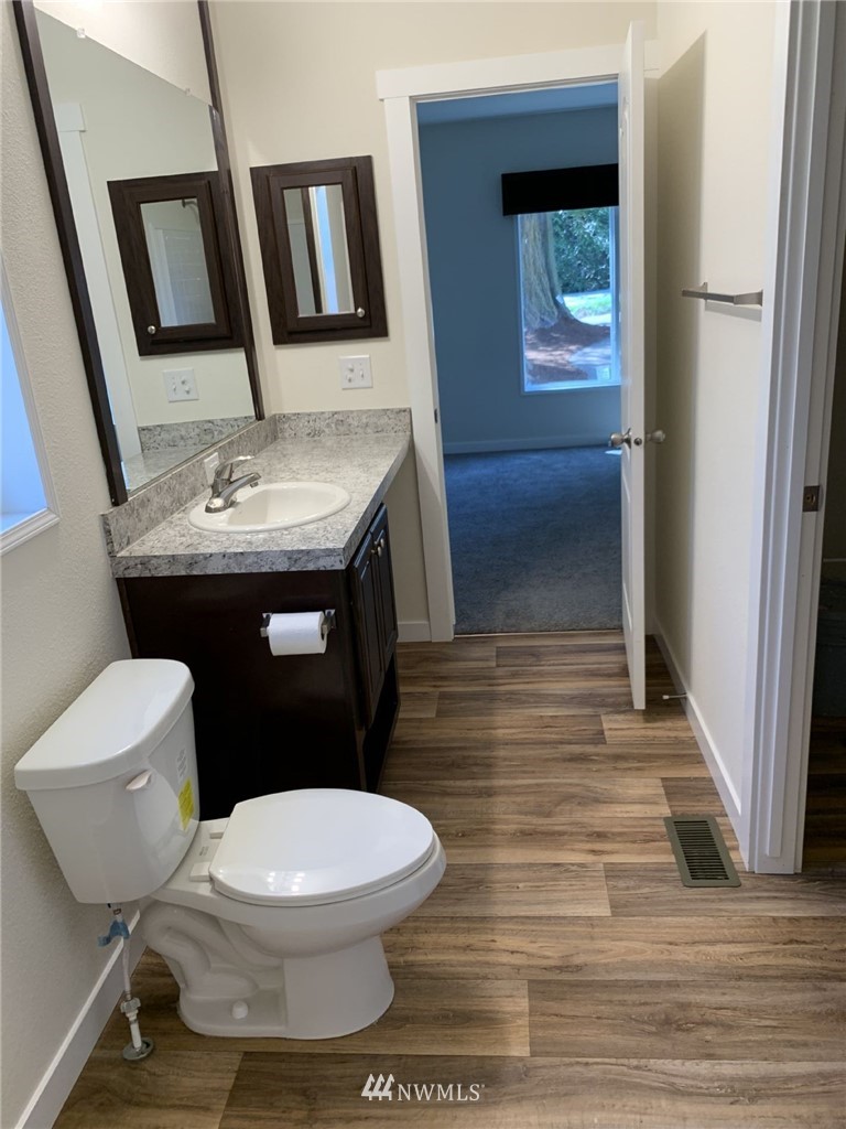 4590 Lake Terrell Road Ferndale, WA 98248 - Photo 14 of 25 a white toilet sitting next to a bathroom sink