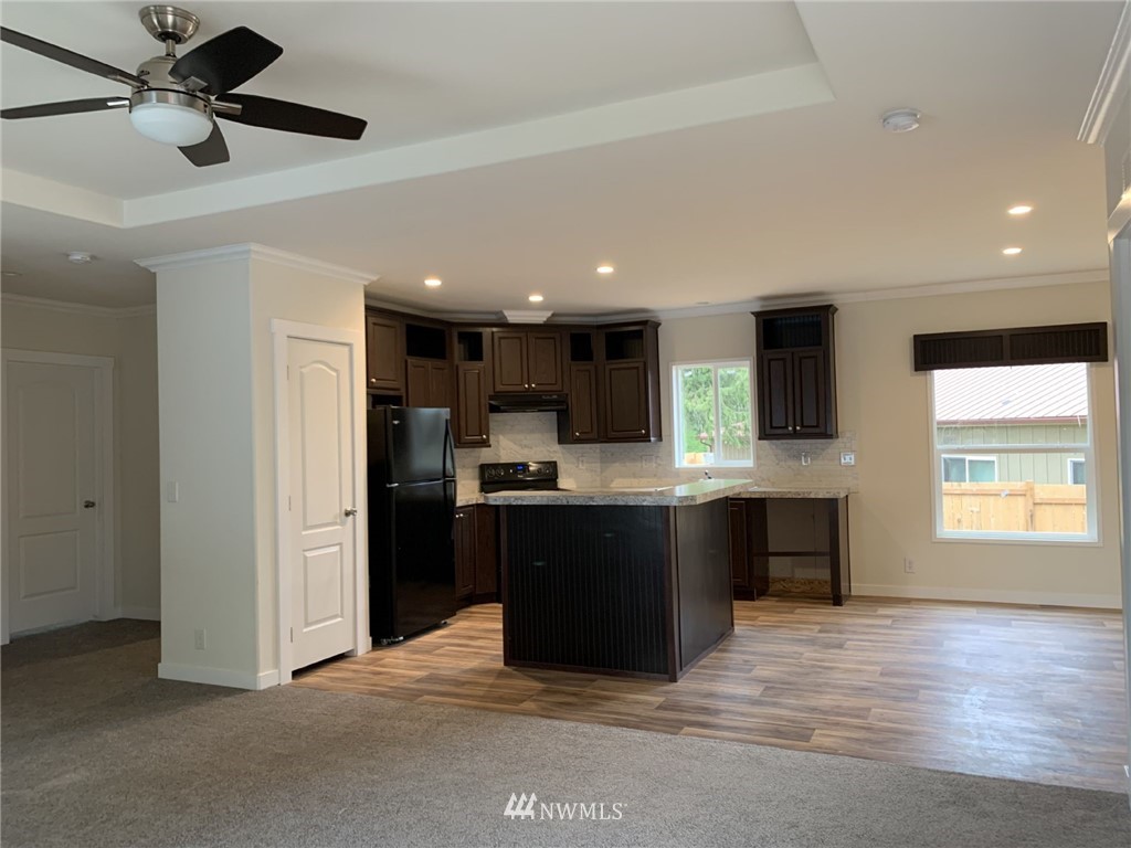 4590 Lake Terrell Road Ferndale, WA 98248 - Photo 6 of 25 a kitchen with kitchen island granite countertop a stove top oven a sink and a refrigerator