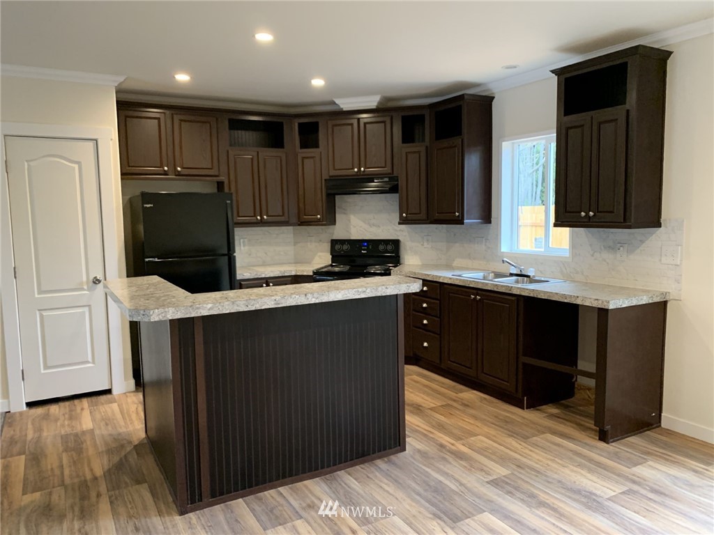 4590 Lake Terrell Road Ferndale, WA 98248 - Photo 7 of 25 a kitchen with stainless steel appliances granite countertop a refrigerator and a stove top oven
