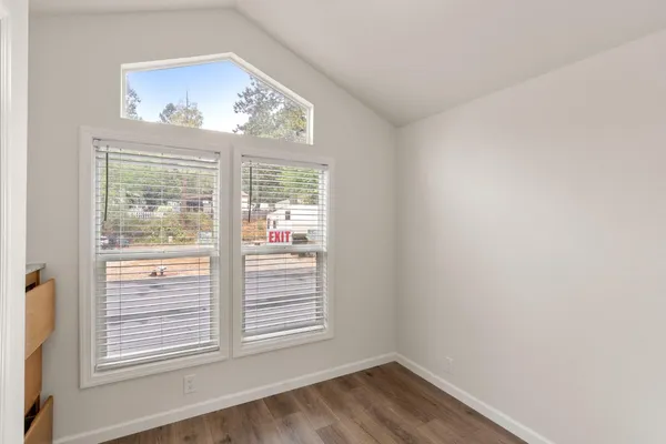 a bedroom with a bed and a painting on the wall