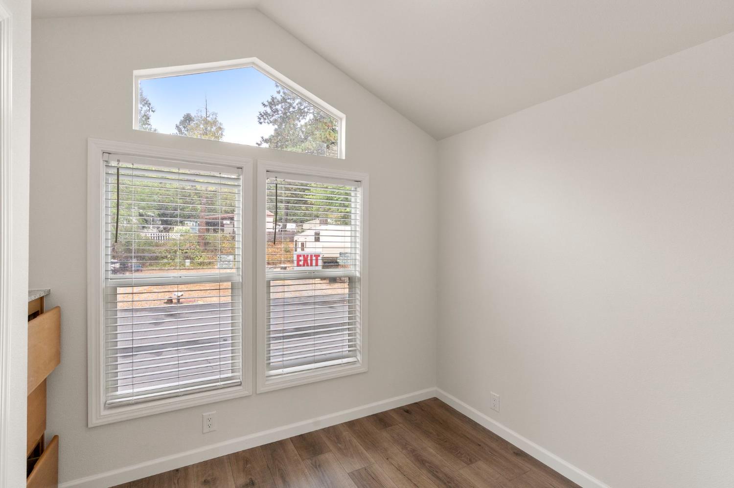 4482 Moran Road, Unit 56 Avery, CA 95224 - Photo 11 of 17 a view of an empty room with wooden floor and a window