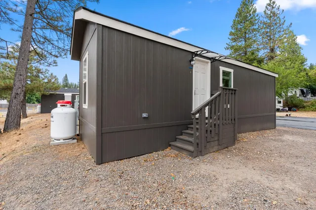a kitchen with granite countertop a stove a refrigerator and a stove top oven