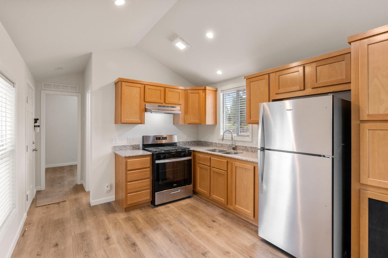 4482 Moran Road, Unit 56 Avery, CA 95224 - Photo 8 of 17 a kitchen with stainless steel appliances granite countertop a refrigerator stove and a sink