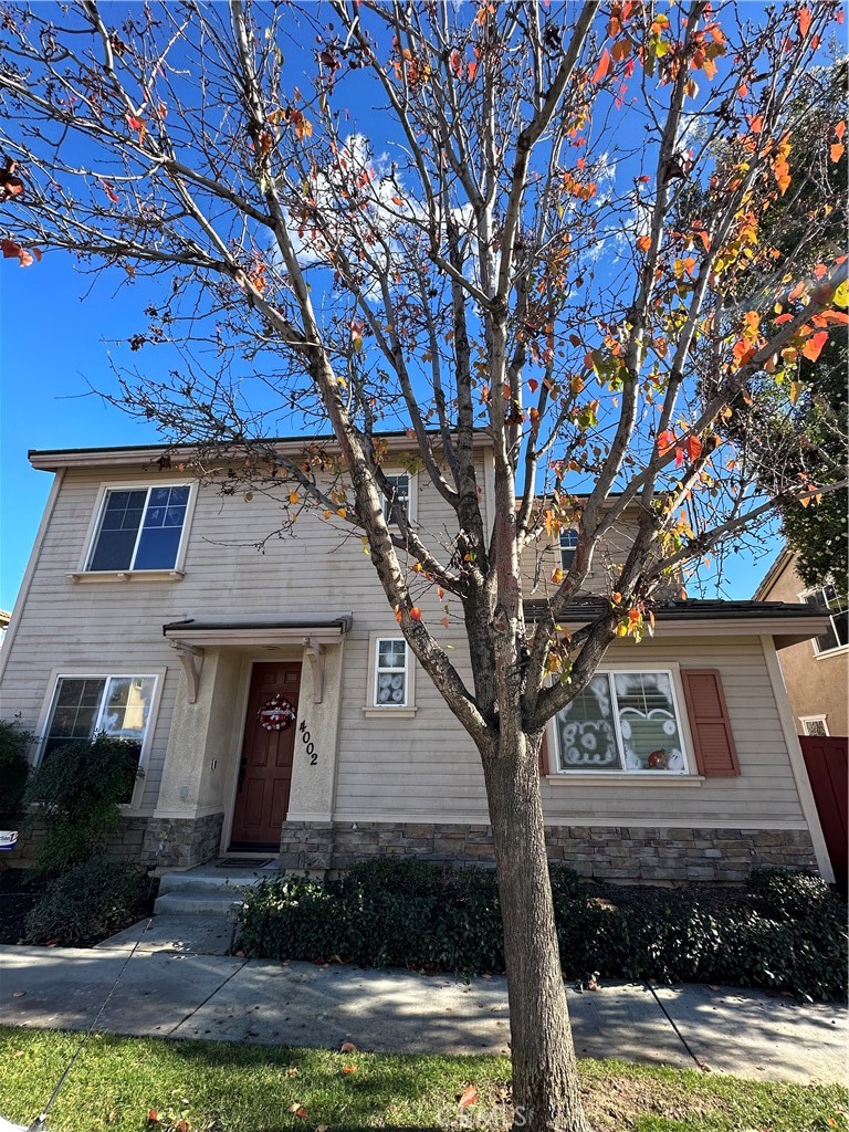 4002 Landau Court Riverside, CA 92501 - Photo 1 of 1 a front view of a house with yard garage and tree