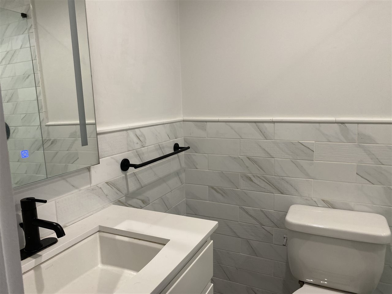 1024 Clinton Street, Unit 502 Hoboken, NJ 07030 - Photo 11 of 17 a bathroom with a sink a toilet and shower