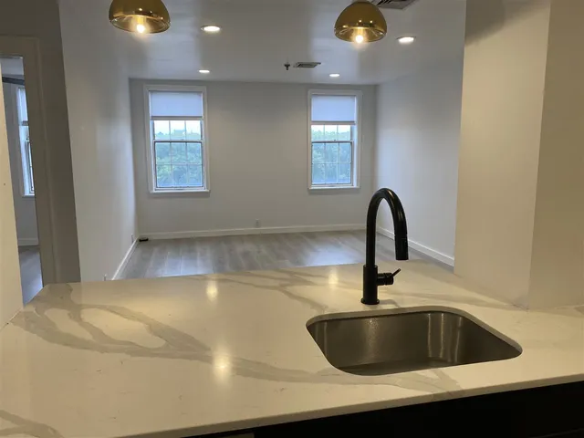 a kitchen with a sink and chandelier