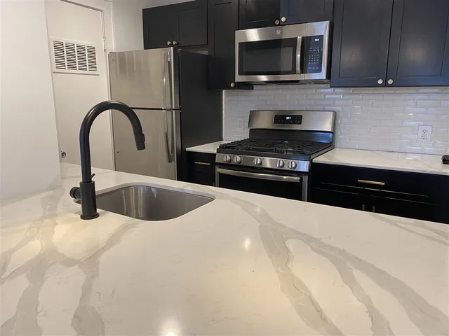 a kitchen with a stove and a microwave