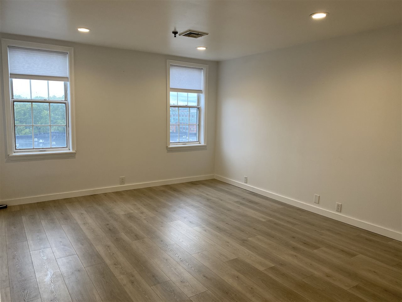 1024 Clinton Street, Unit 502 Hoboken, NJ 07030 - Photo 8 of 17 an empty room with wooden floor and windows