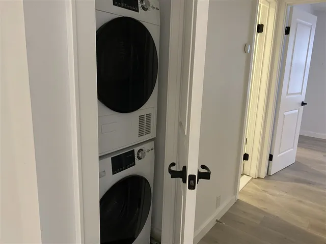 a view of a hallway with washer and dryer